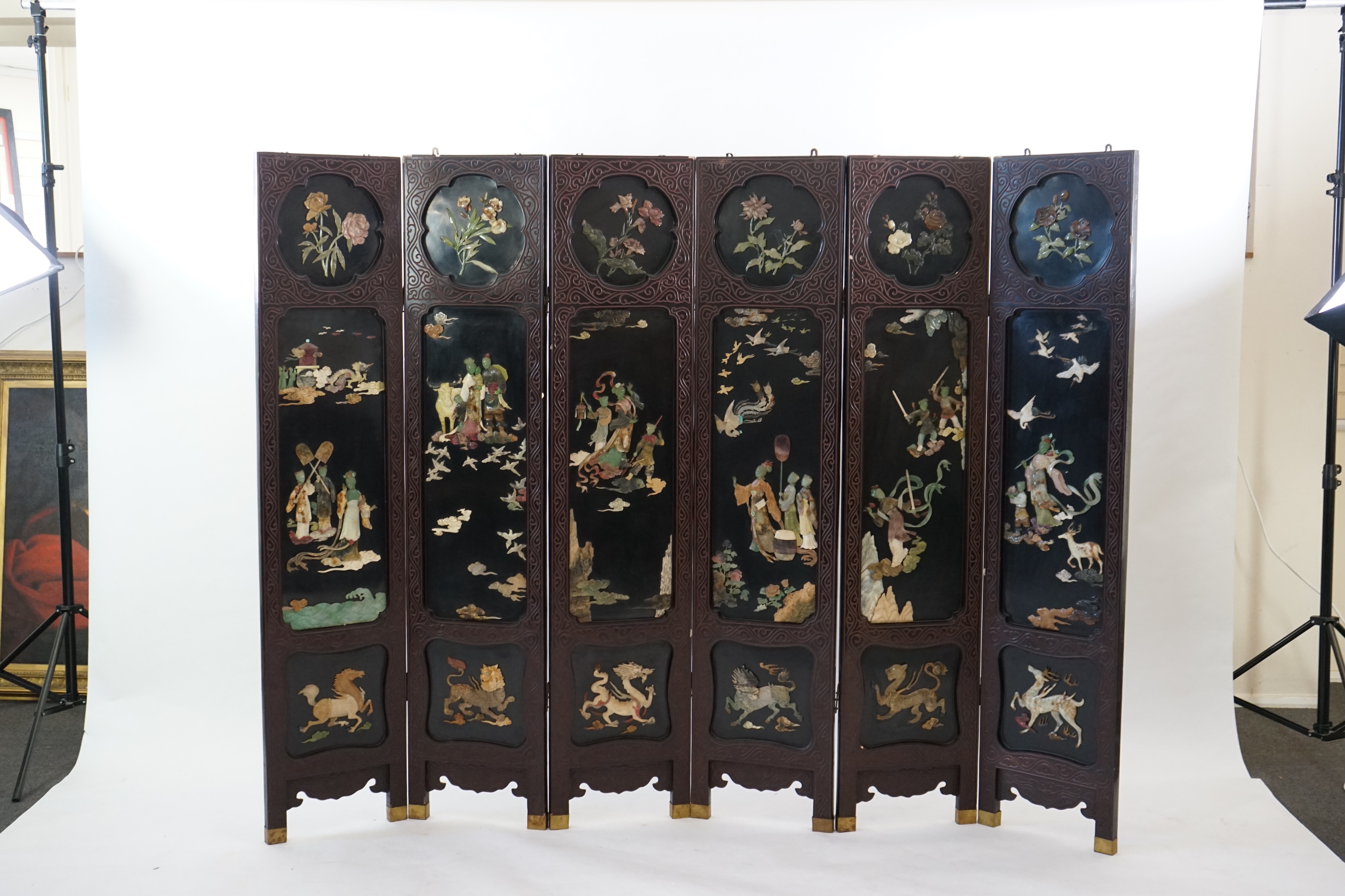 A Chinese tixi lacquer and carved soapstone overlaid six panel screen, mid 20th century